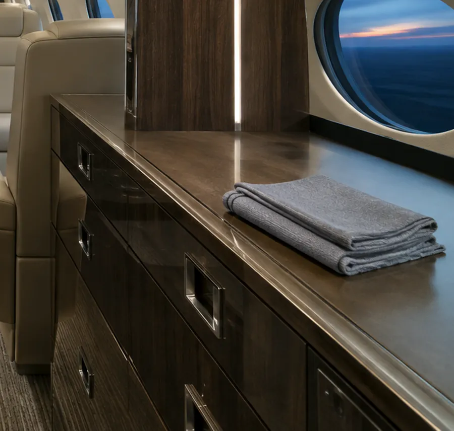 Detail of a polished galley cabinet and service area in a business jet cabin